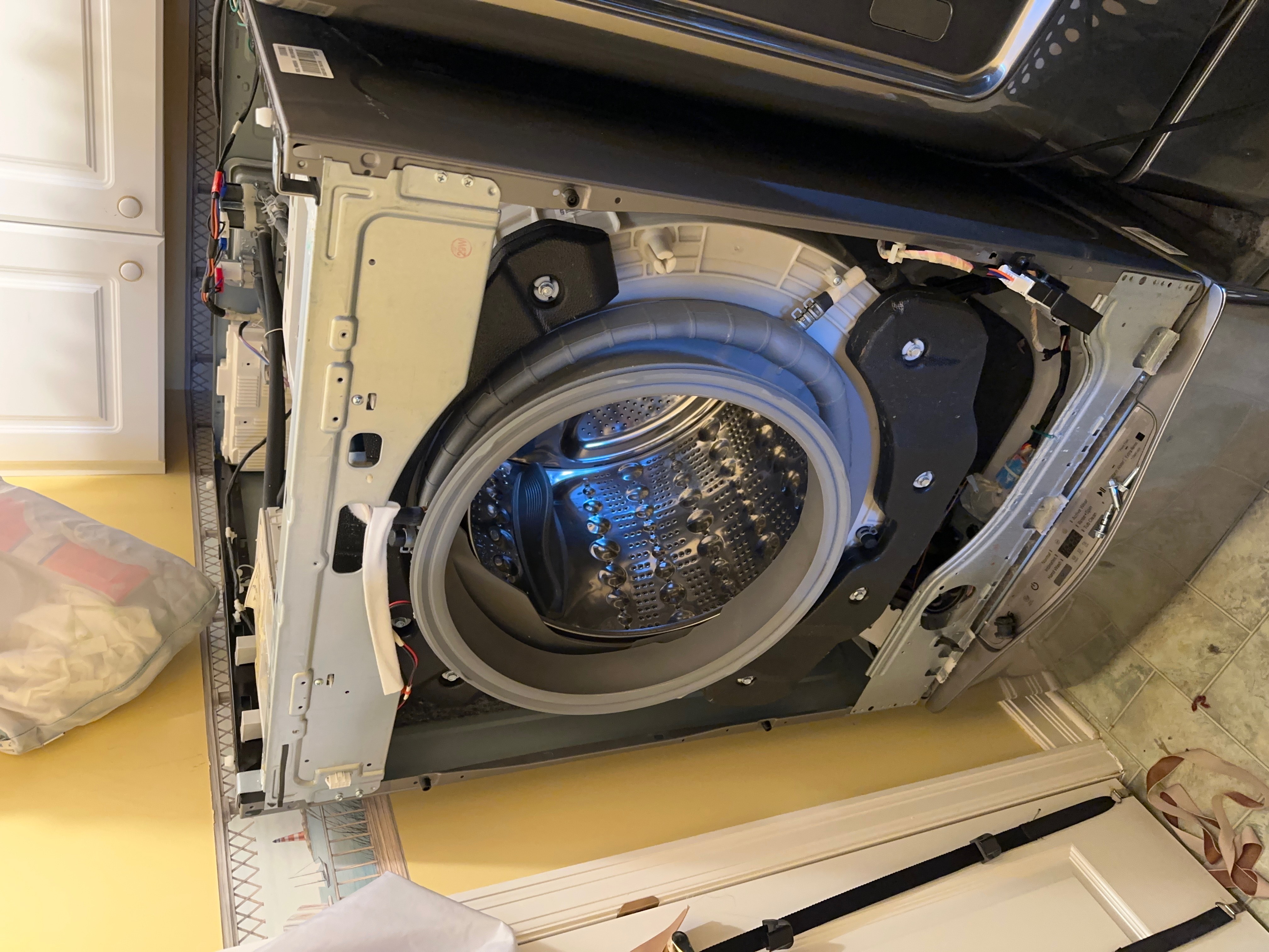 Washer disassembly during drain pump inspection in Ottawa